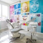 a modern dental office features a gleaming, state-of-the-art dental chair with a vibrant backdrop of colorful oral health posters, emphasizing the importance of dental floss for a bright, healthy smile.